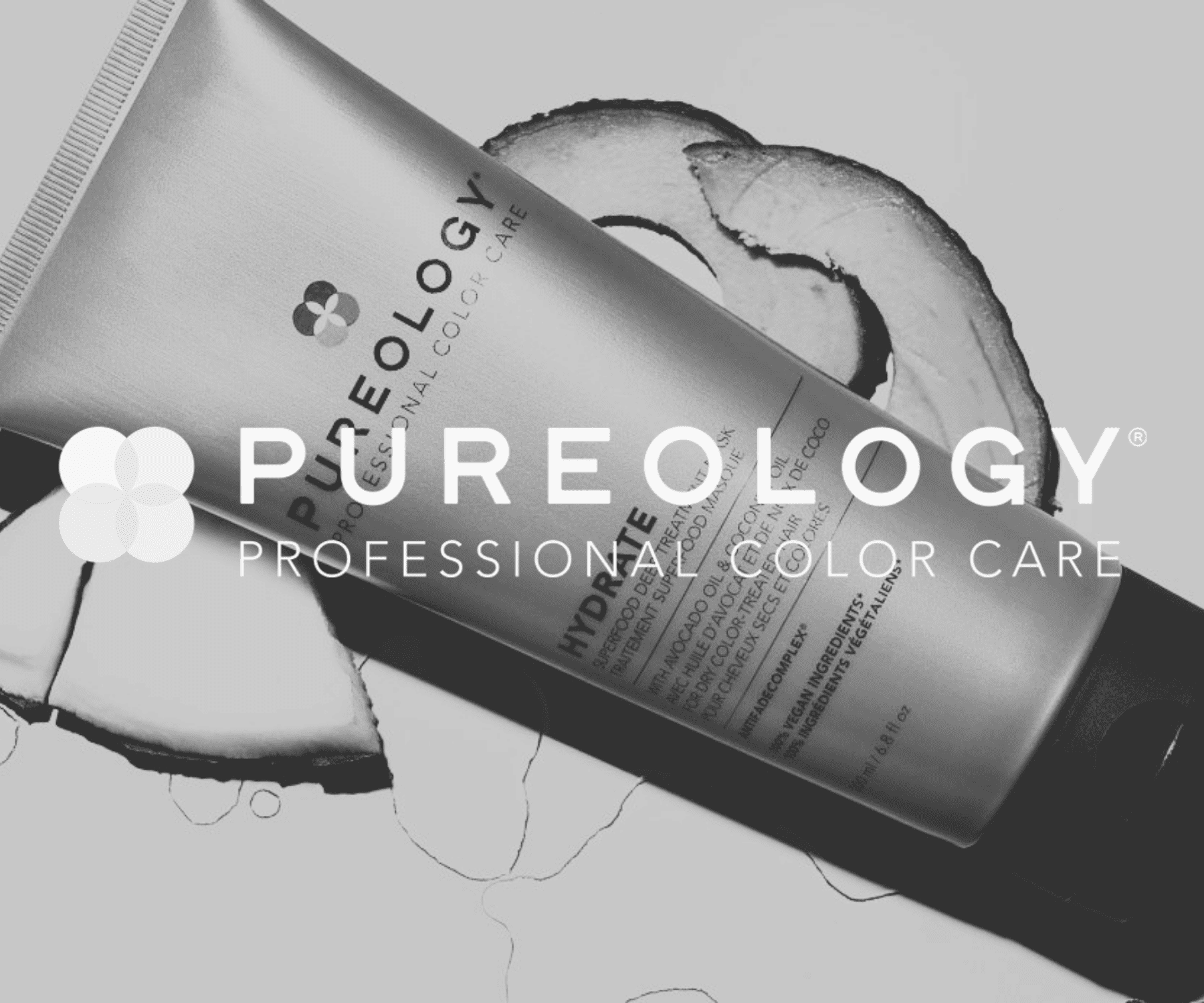 Pureology Hydrate shampoo tube with coconut slices backdrop. Perfect for color-treated hair.