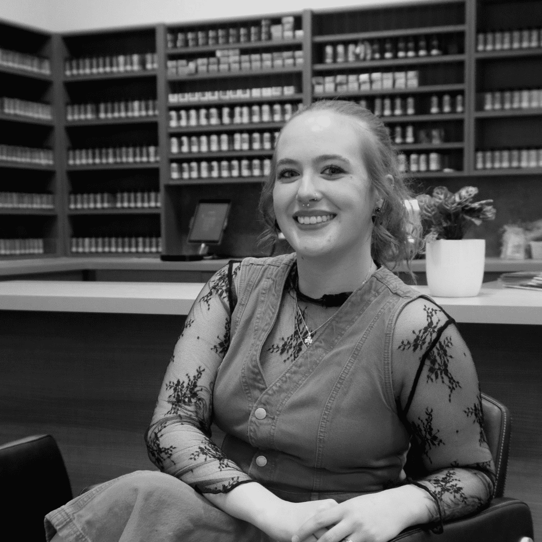 Portrait of Teigan Maniatis, a professional stylist at Yacht Club Salon, showcasing their expertise and style.
