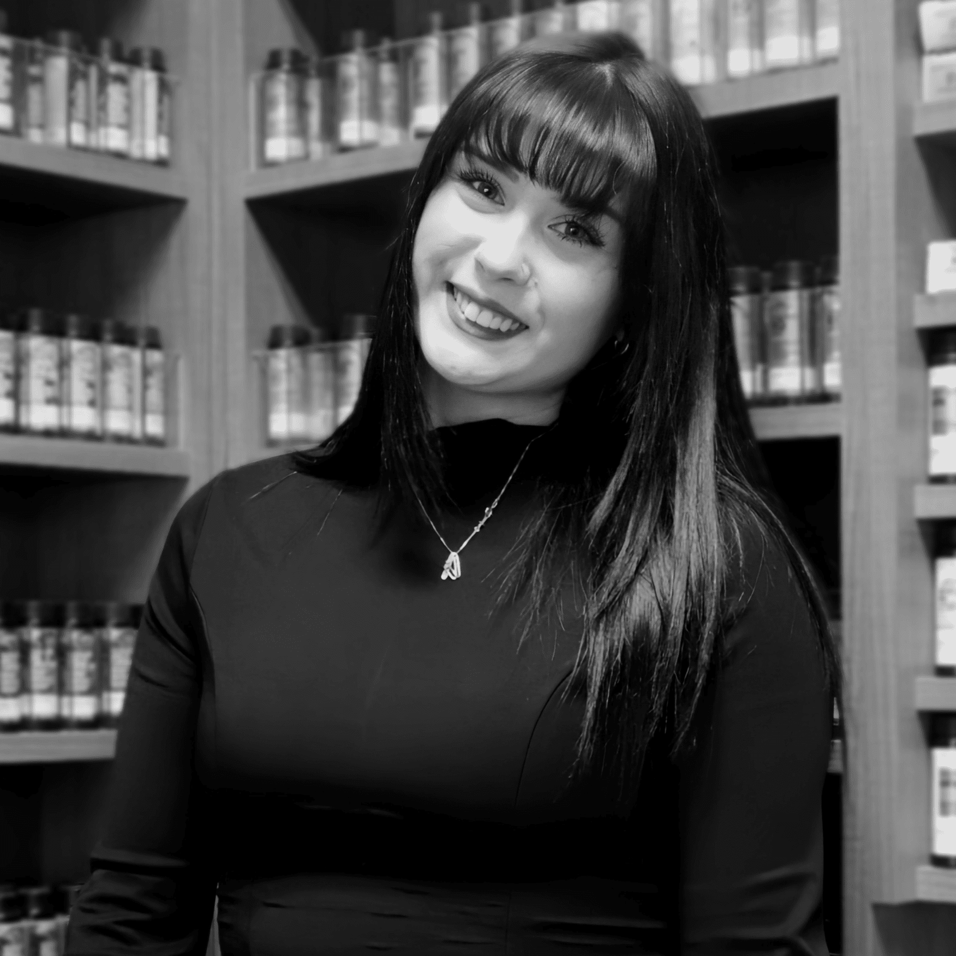 Portrait of Alexis White, a professional stylist at Yacht Club Salon, showcasing their expertise and style.