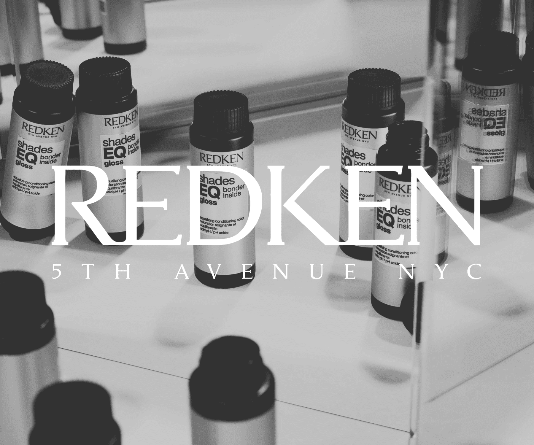 Hair products displayed with "Redken 5th Avenue NYC" branding. Black and white image.