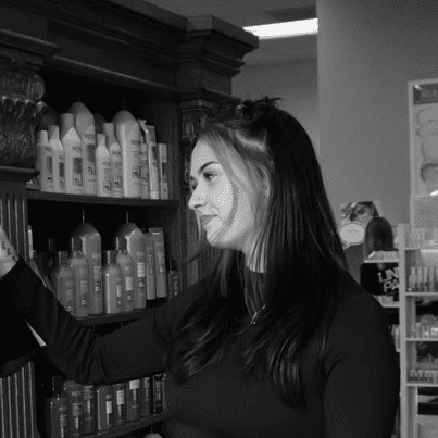 Portrait of Alexis White, a professional stylist at Yacht Club Salon, showcasing their expertise and style.